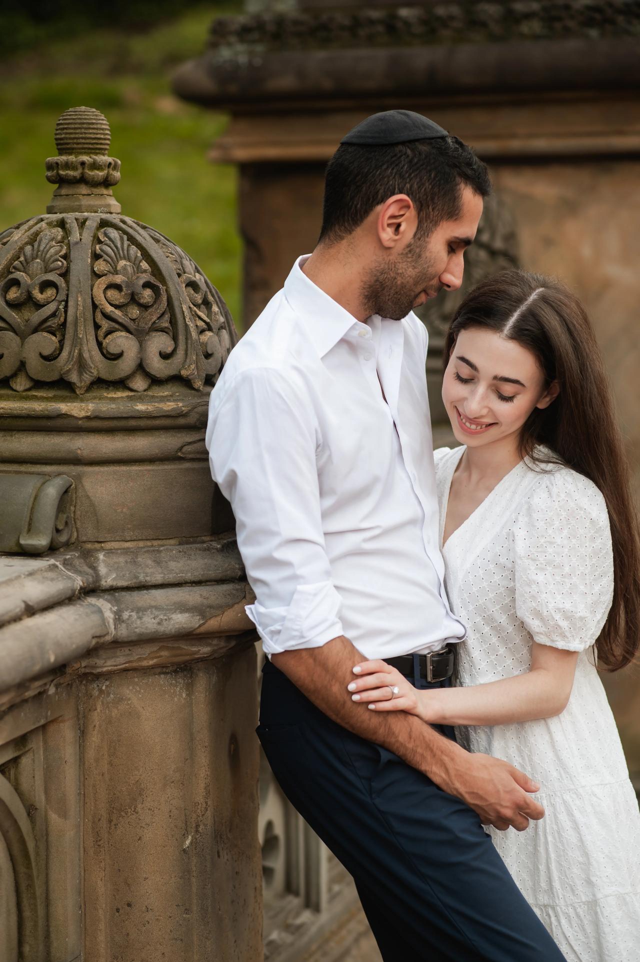 Quiet couple portrait beside a carved stone balustrade