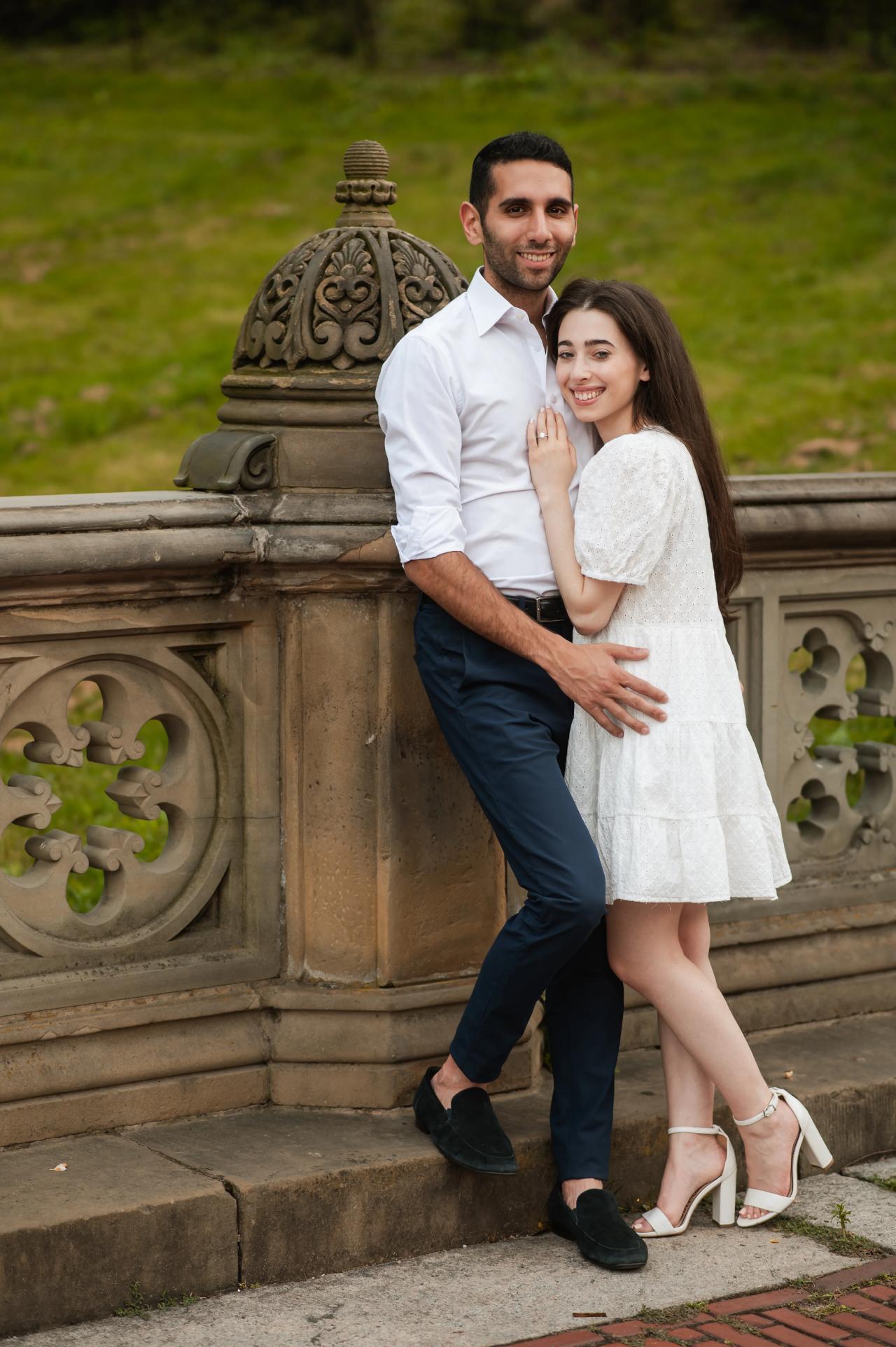 Full-length engagement portrait on a stone terrace
