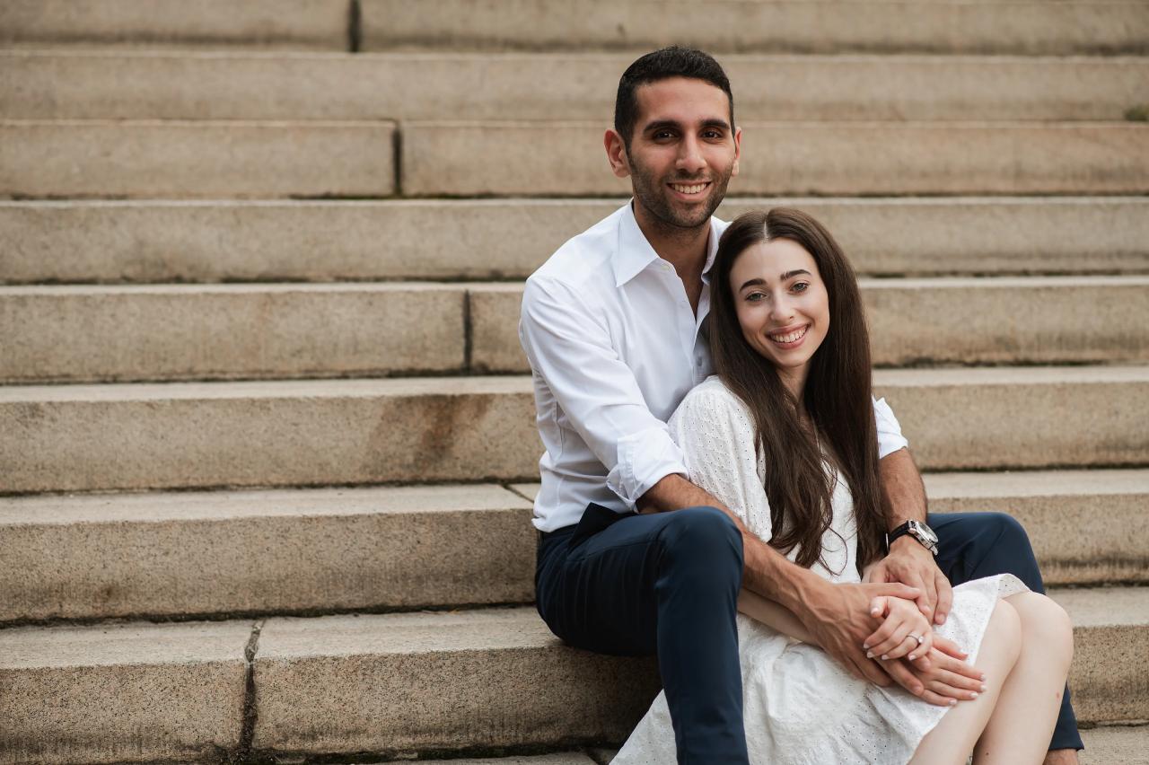 Couple sitting together on broad stone steps