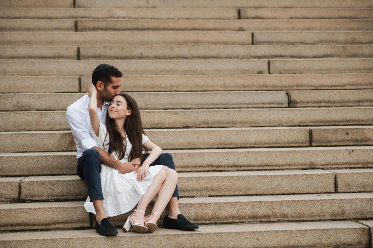 Couple sharing a quiet embrace on stone steps