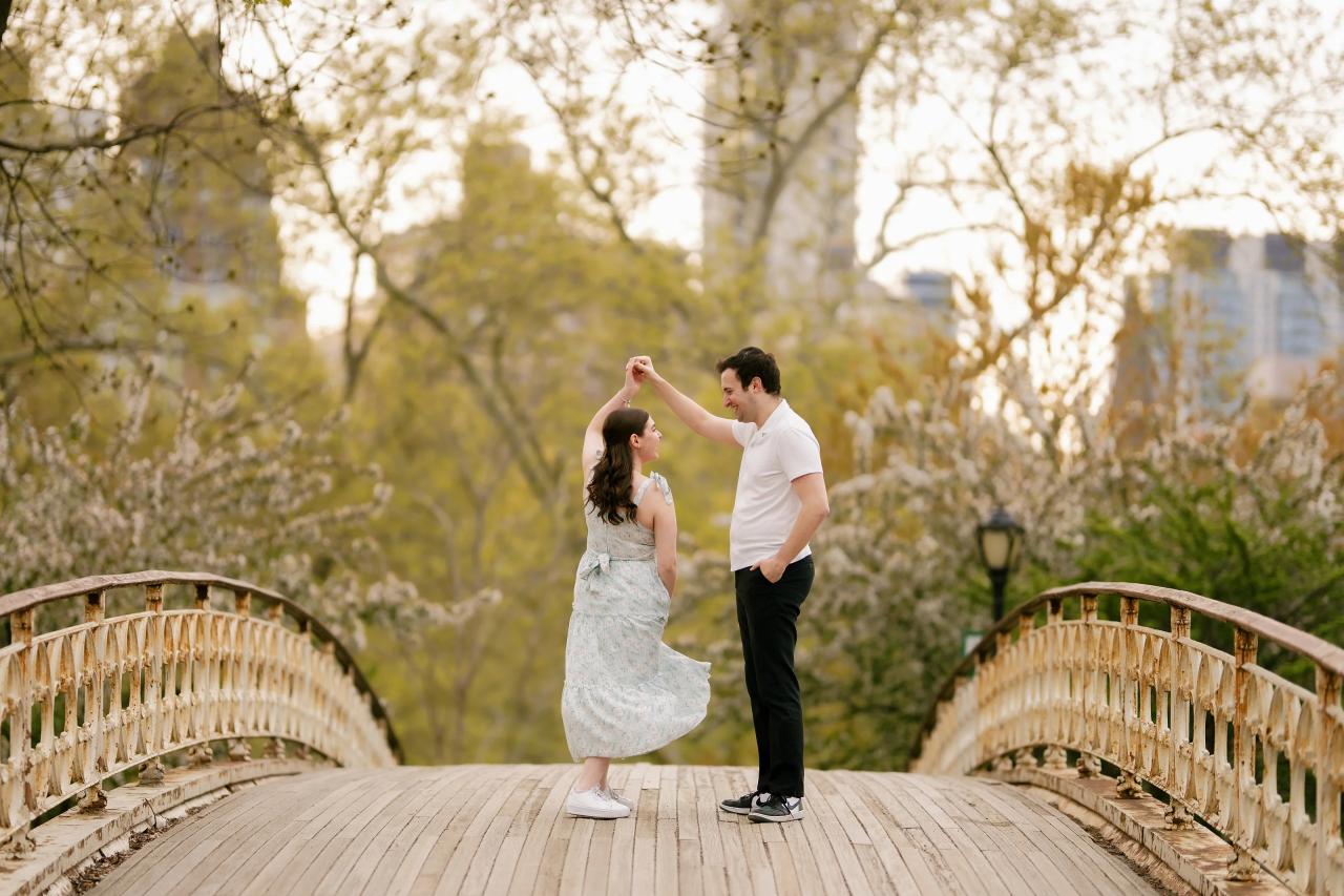 Couple twirling on an ornate footbridge