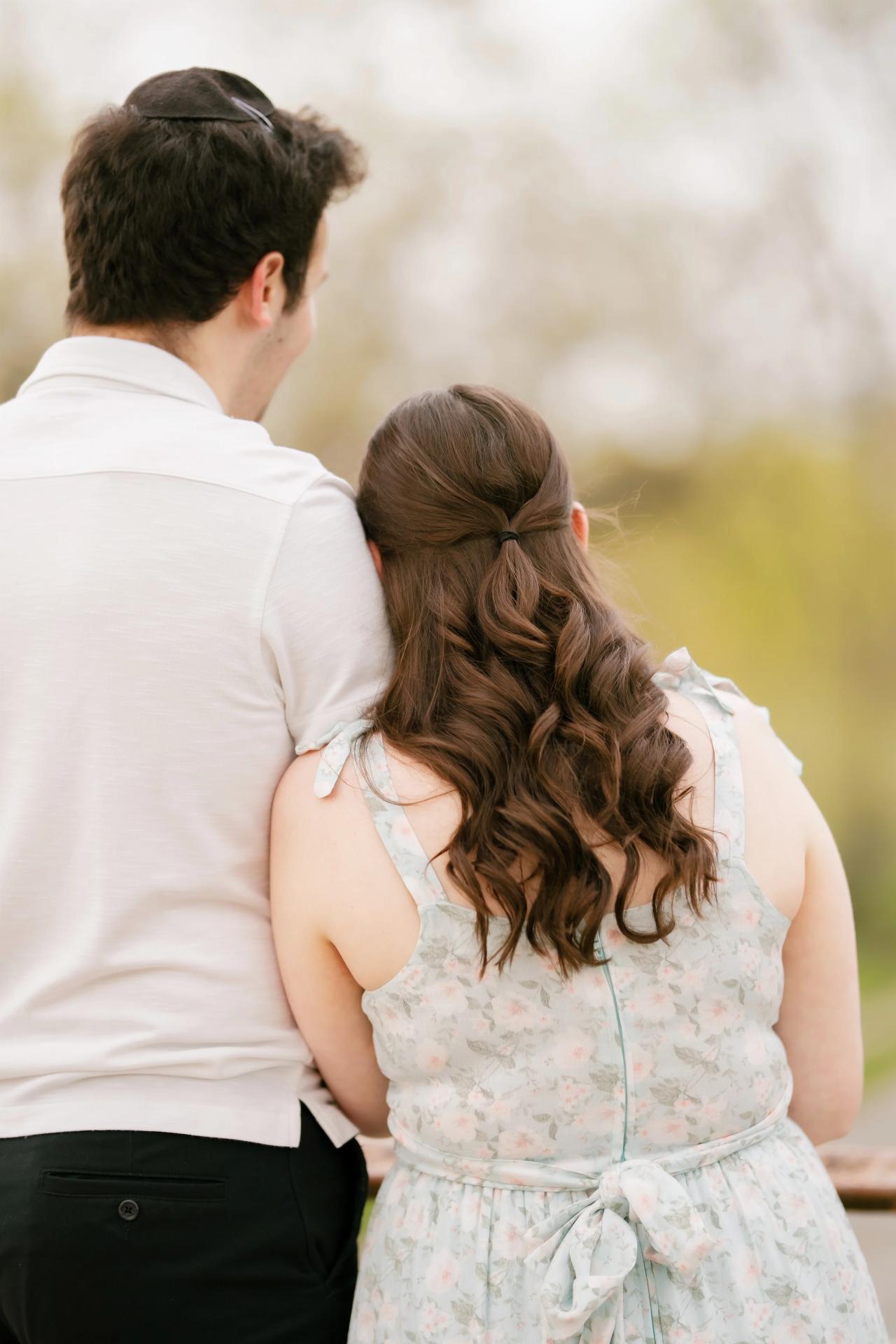 Couple looking across the water from a bridge