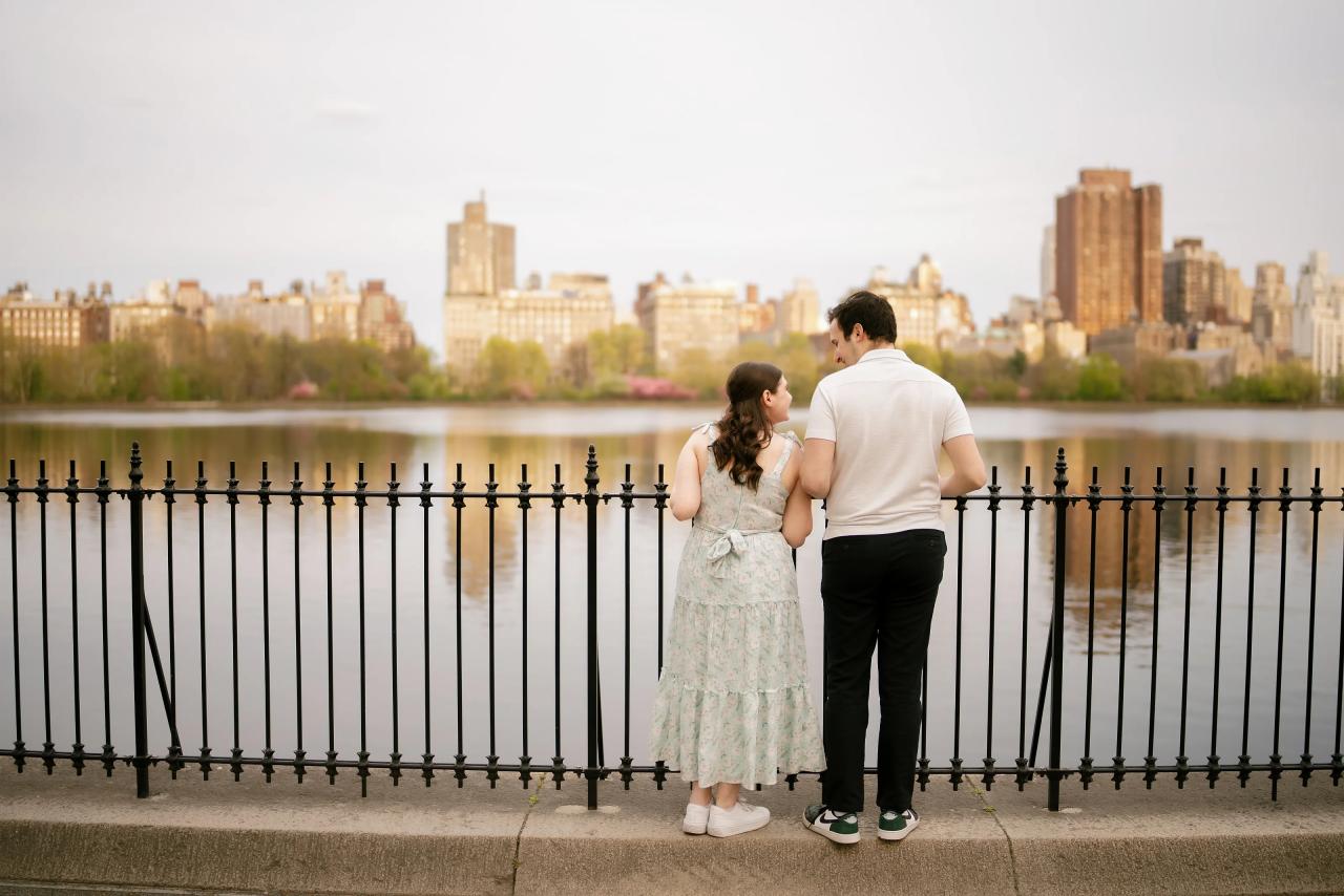 Couple looking across a lake toward the city skyline