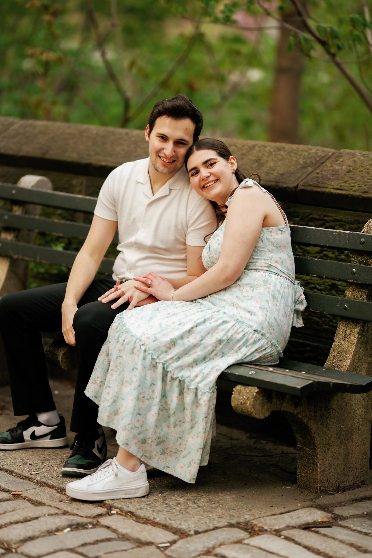 Couple seated together on a park bench