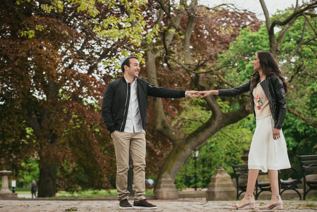 Couple holding hands beneath a canopy of branches