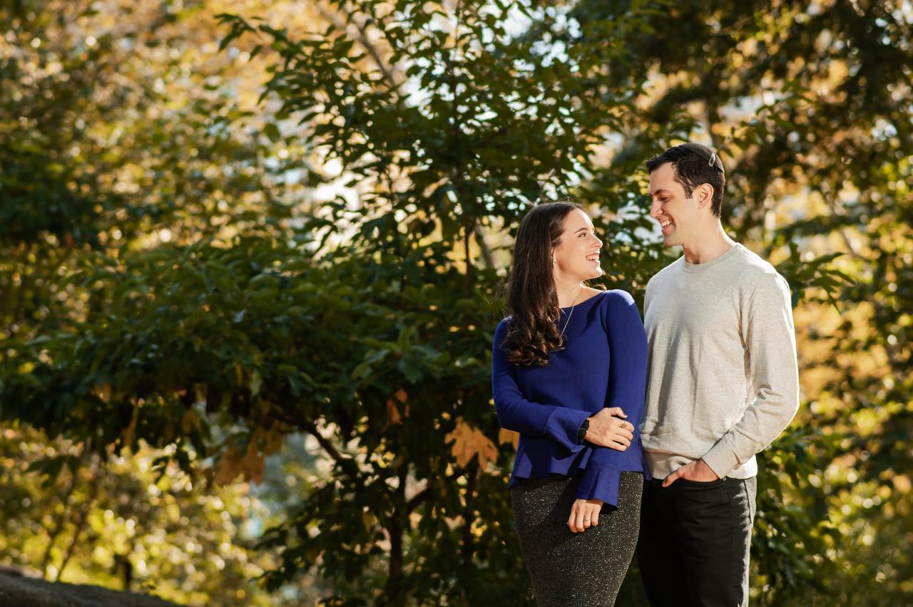 Couple smiling at each other in warm autumn light