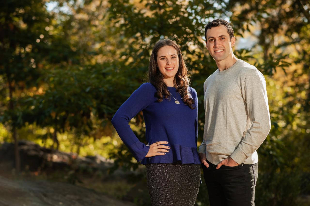Close engagement portrait beneath golden leaves