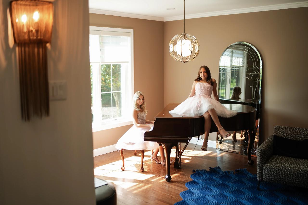 Twin sisters together at a grand piano before their celebration