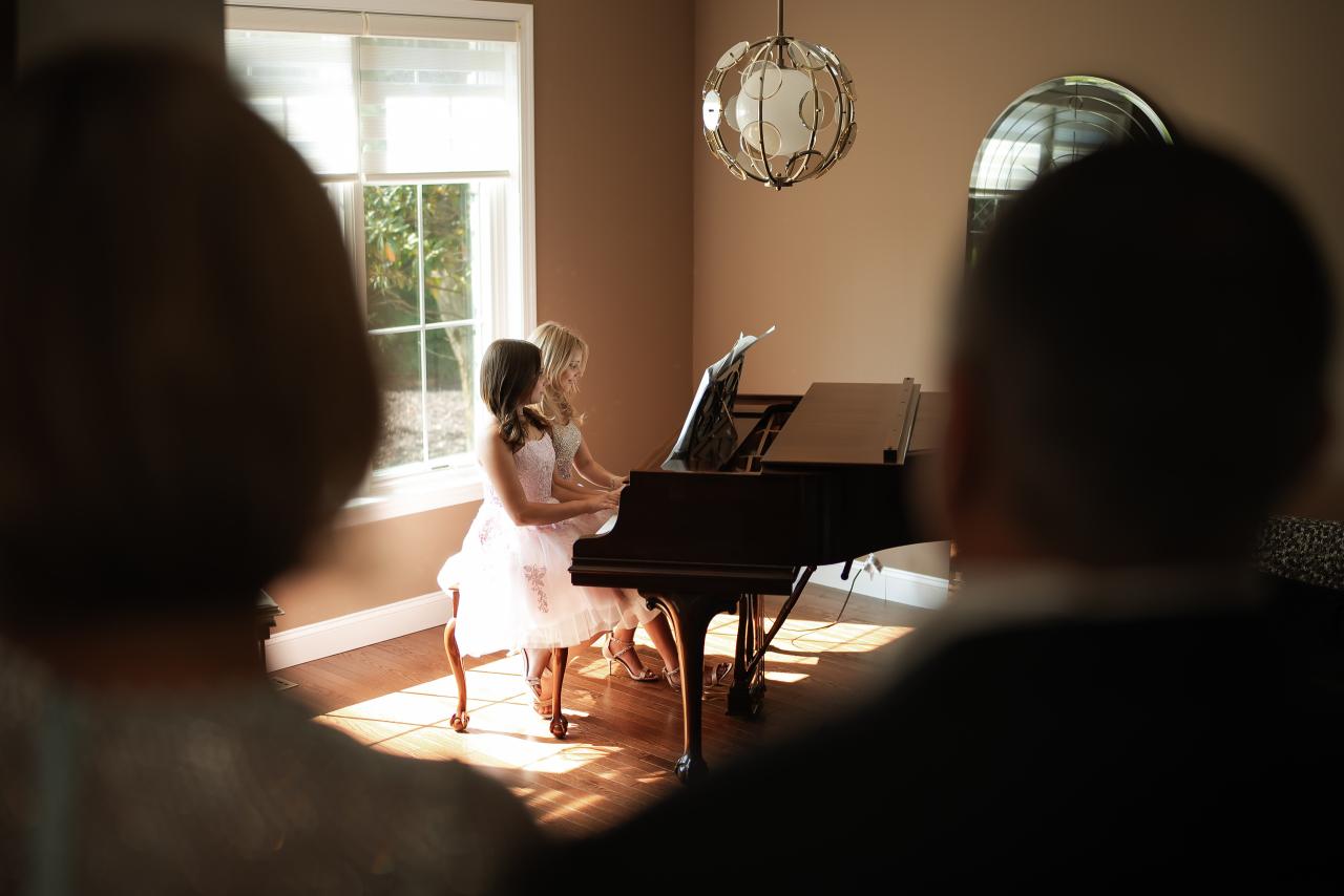 Guests watching a piano performance before the twin bat mitzvah celebration