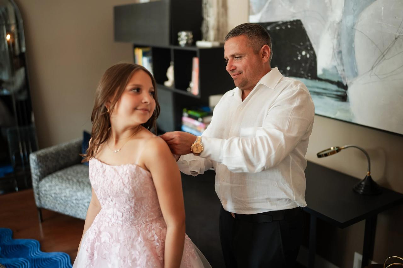 A family member helping a sister get ready for her bat mitzvah