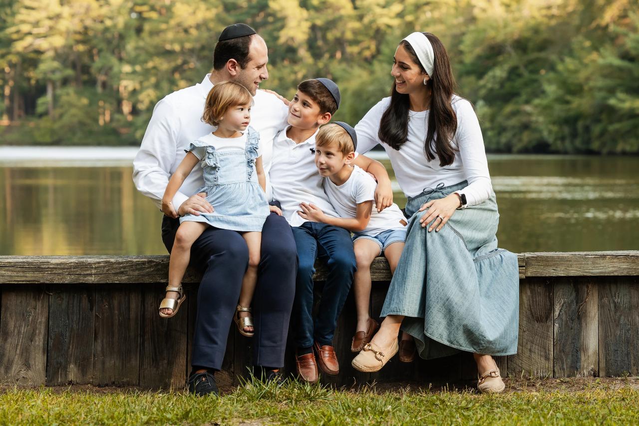 Family sharing a candid moment while seated together beside the water