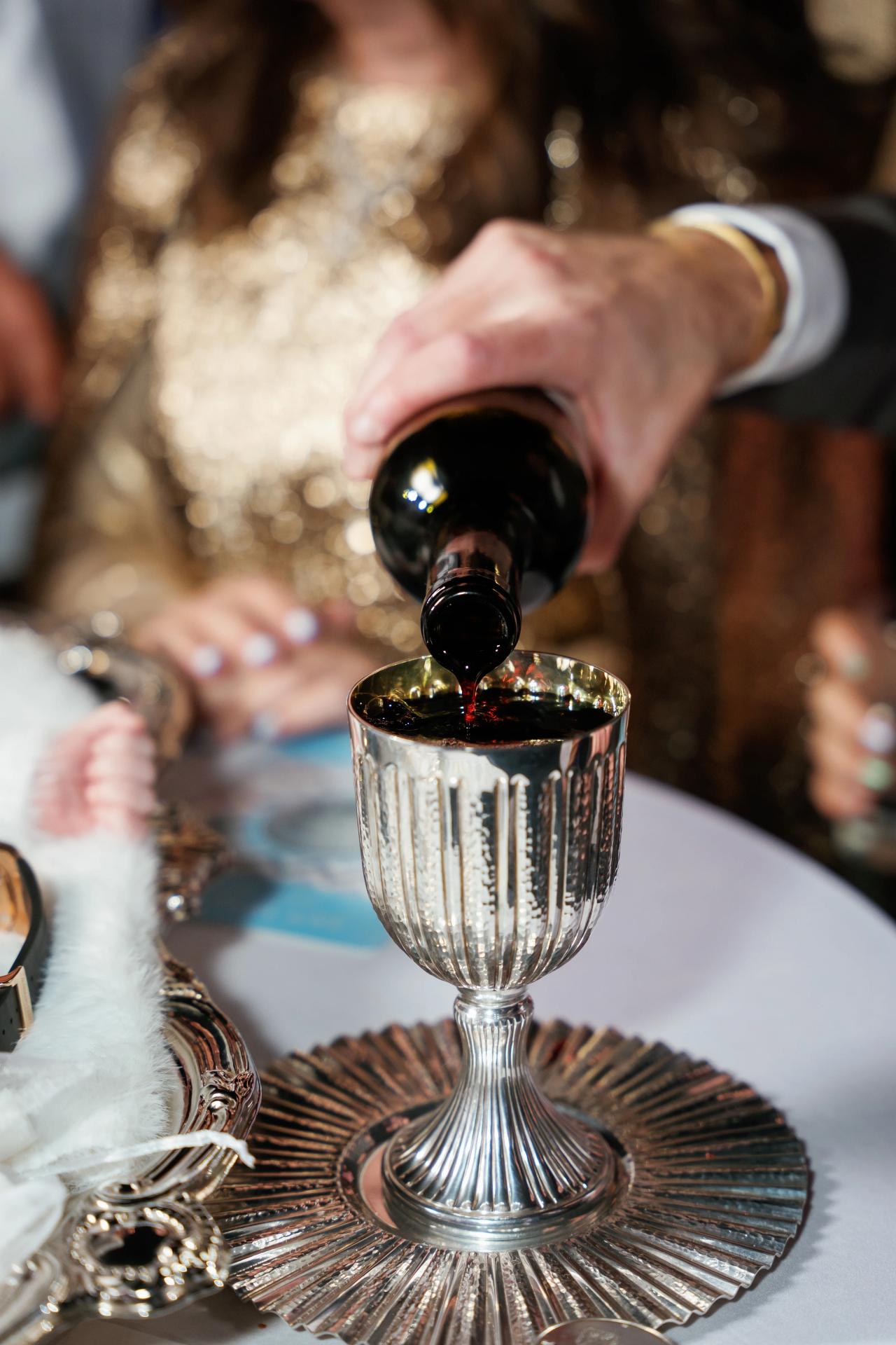Wine being poured into a silver cup during the Pidyon Haben ceremony