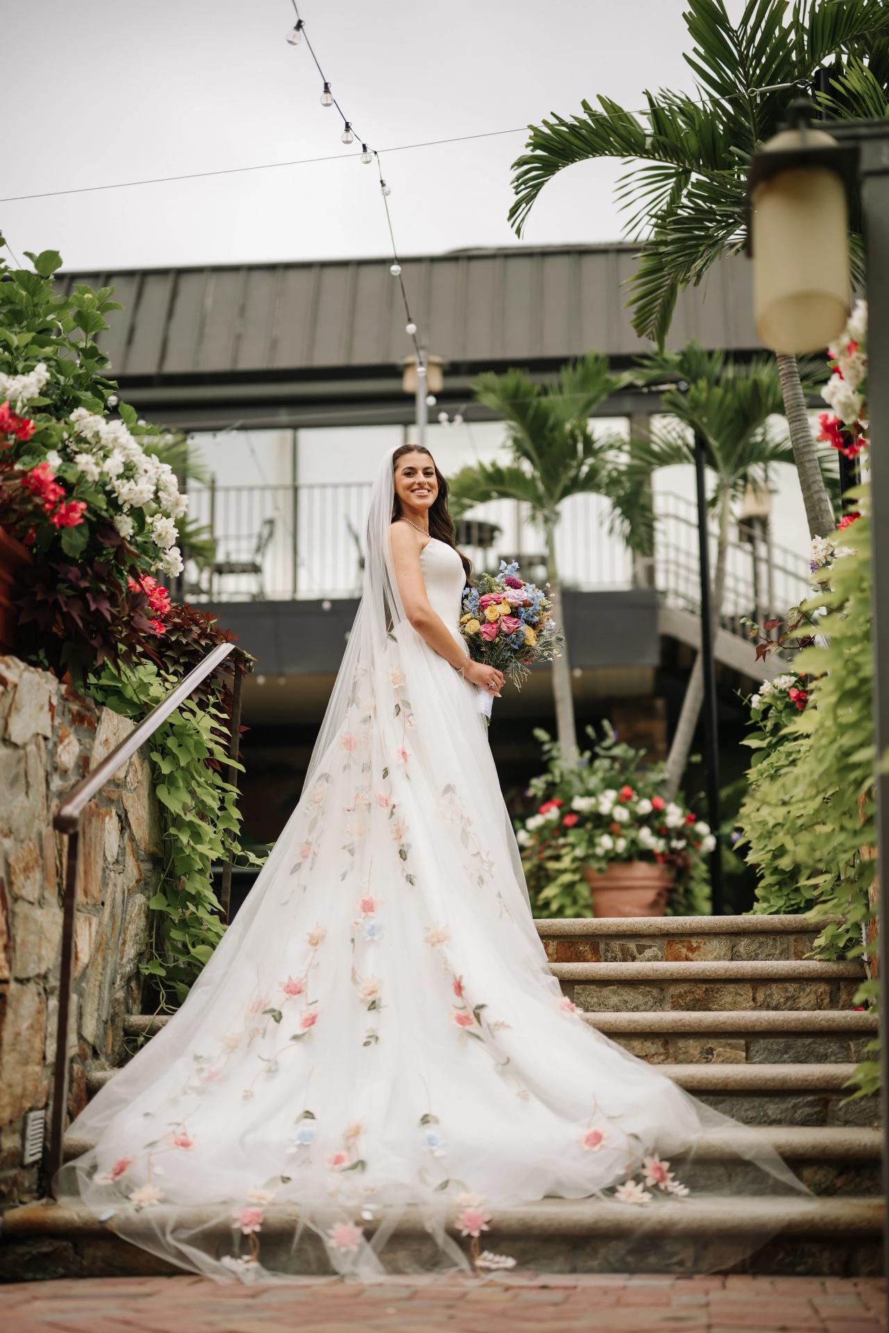 Bride wearing an embroidered veil on the garden steps. Crest Hollow wedding in Woodbury, Long Island.