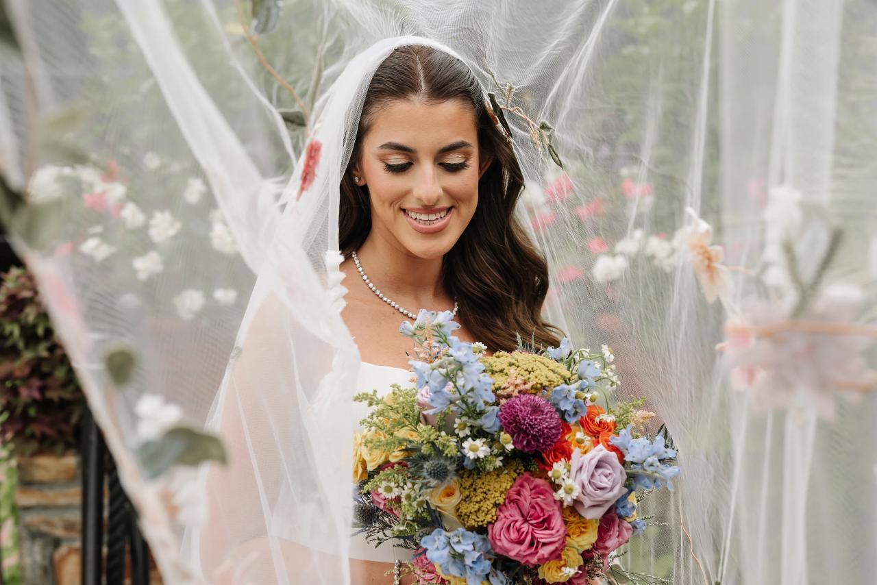 Bride smiling beneath her sheer wedding veil. Crest Hollow wedding in Woodbury, Long Island.