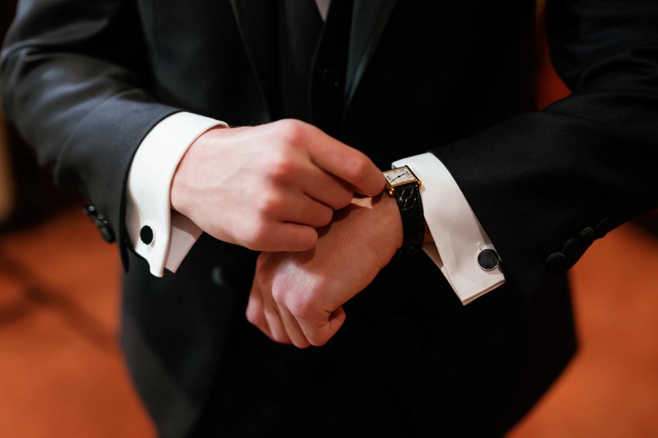Groom adjusting his wedding-day cufflinks. Crest Hollow wedding in Woodbury, Long Island.
