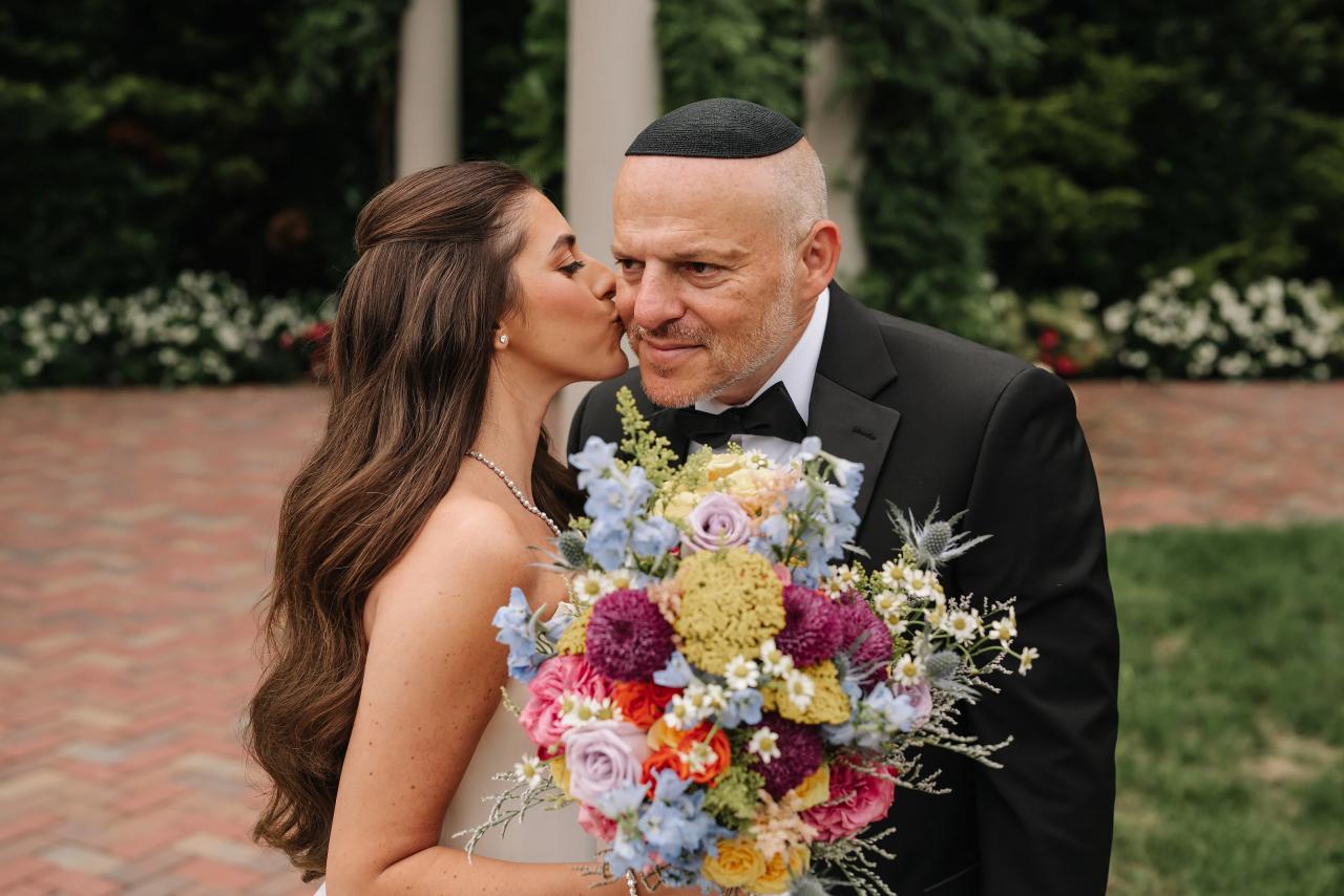 Bride kissing a family member on the cheek. Crest Hollow wedding in Woodbury, Long Island.