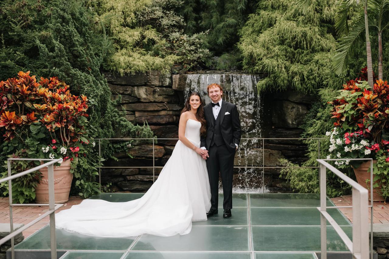 Bride and groom beside the garden waterfall. Crest Hollow wedding in Woodbury, Long Island.