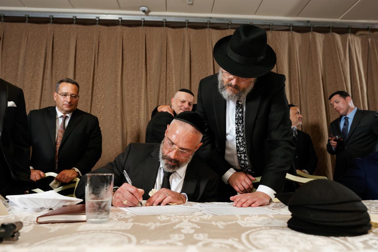 Signing the wedding ketubah before the ceremony. Crest Hollow wedding in Woodbury, Long Island.