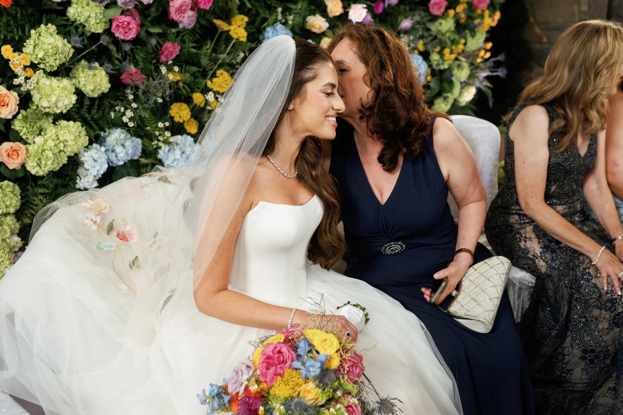 Bride sharing an affectionate moment with a guest. Crest Hollow wedding in Woodbury, Long Island.