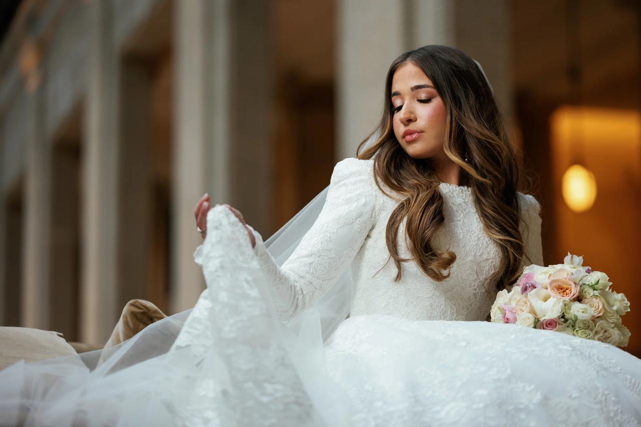 Close bridal portrait with a lace sleeve and soft window light. Jewish wedding in Detroit.