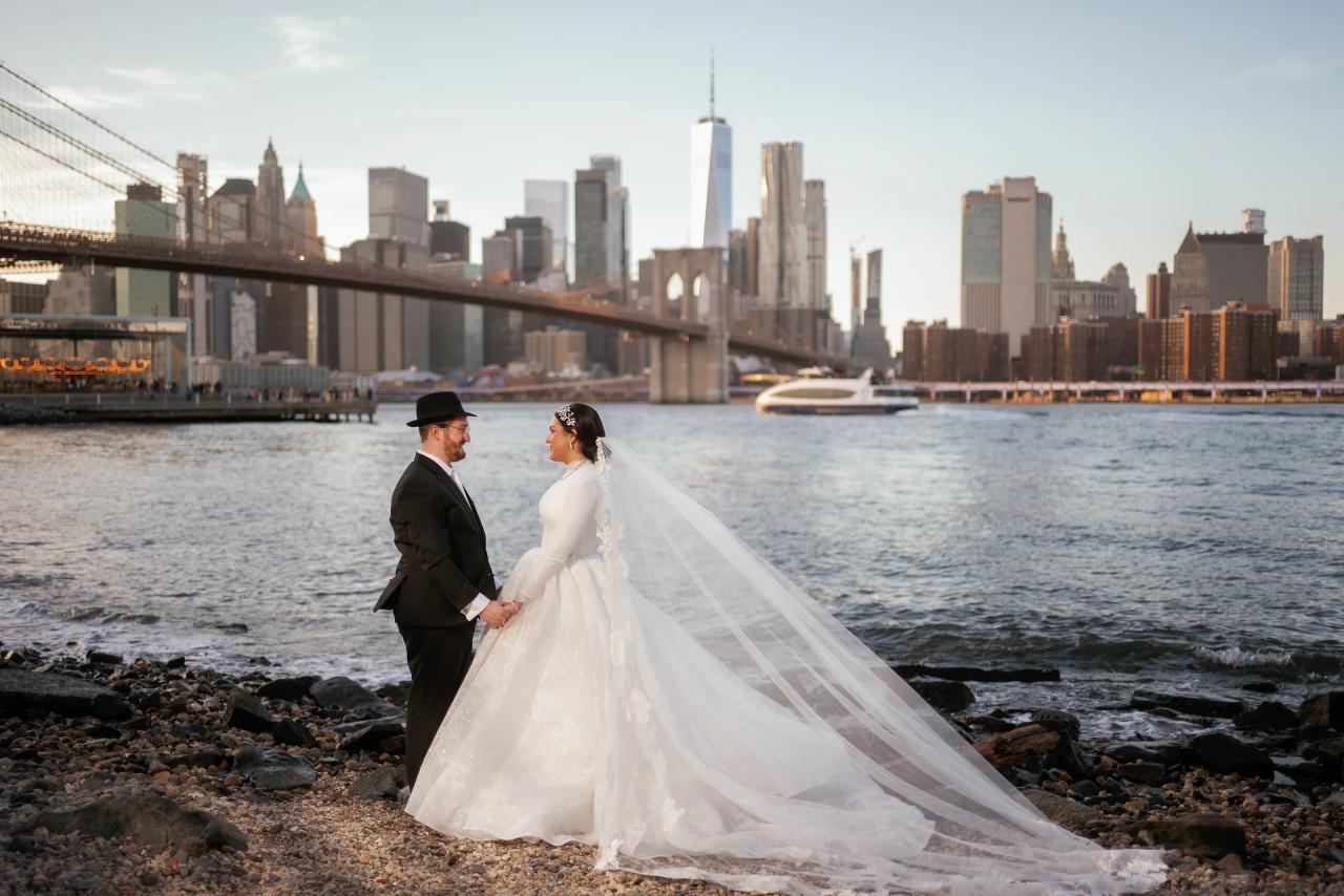 Bride and groom on the Brooklyn waterfront with the Manhattan skyline