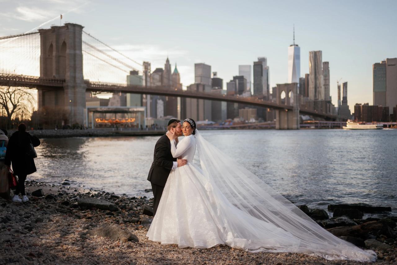 Wedding couple kissing at the river’s edge. Wedding portraits in Brooklyn, NYC.