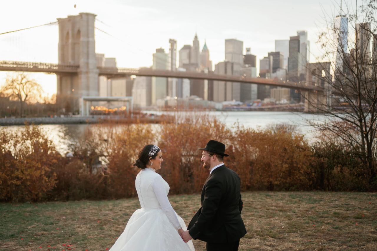 Bride and groom facing one another beside autumn shrubs. Wedding portraits in Brooklyn, NYC.