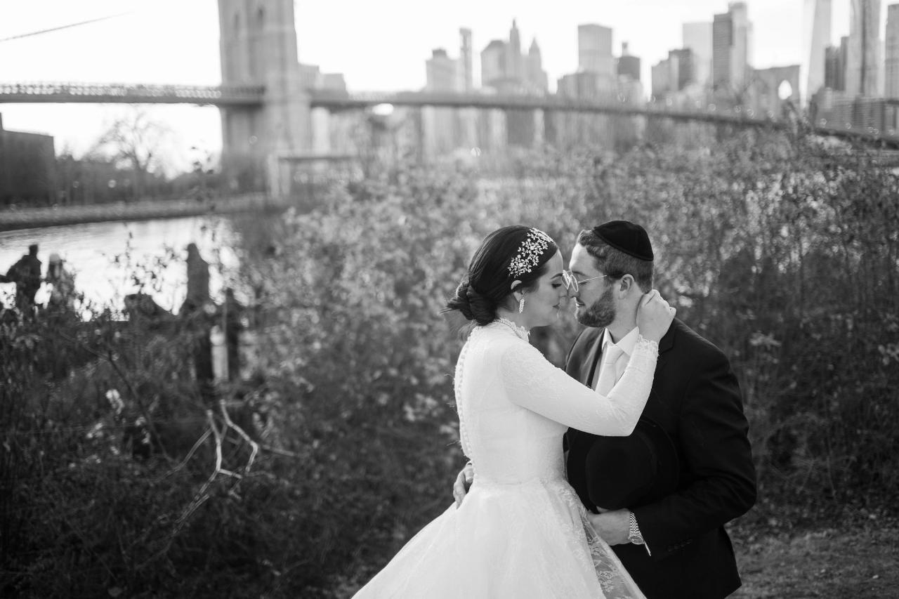 Black-and-white close wedding portrait beside the waterfront. Wedding portraits in Brooklyn, NYC.