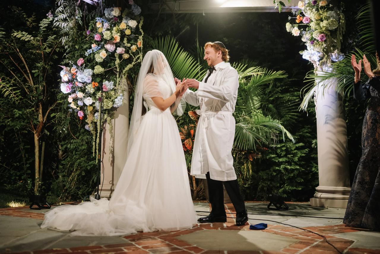 Bride and groom raising a ceremonial cup beneath the chuppah. Crest Hollow wedding in Woodbury, Long Island.
