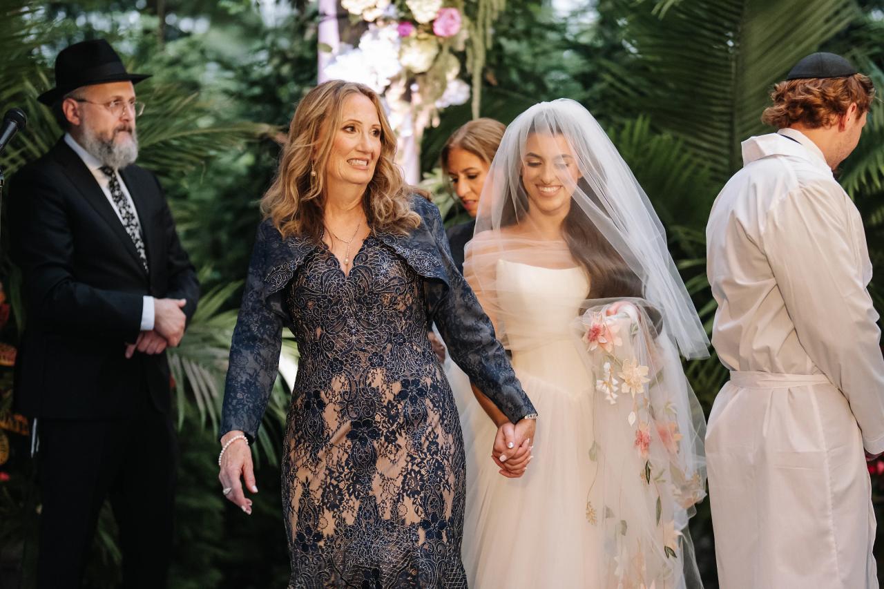 Bride smiling with family during the garden ceremony. Crest Hollow wedding in Woodbury, Long Island.
