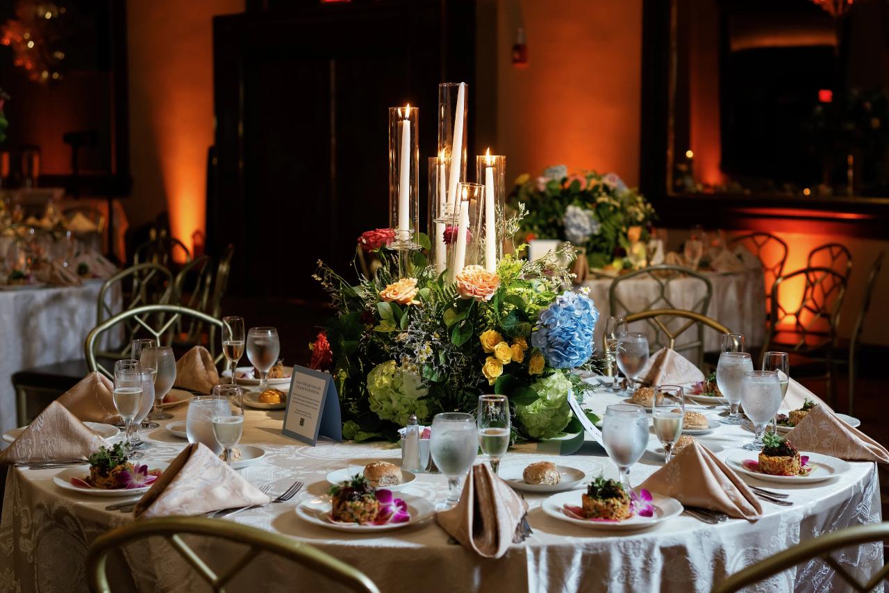 Reception table styled with colorful flowers and candles. Crest Hollow wedding in Woodbury, Long Island.