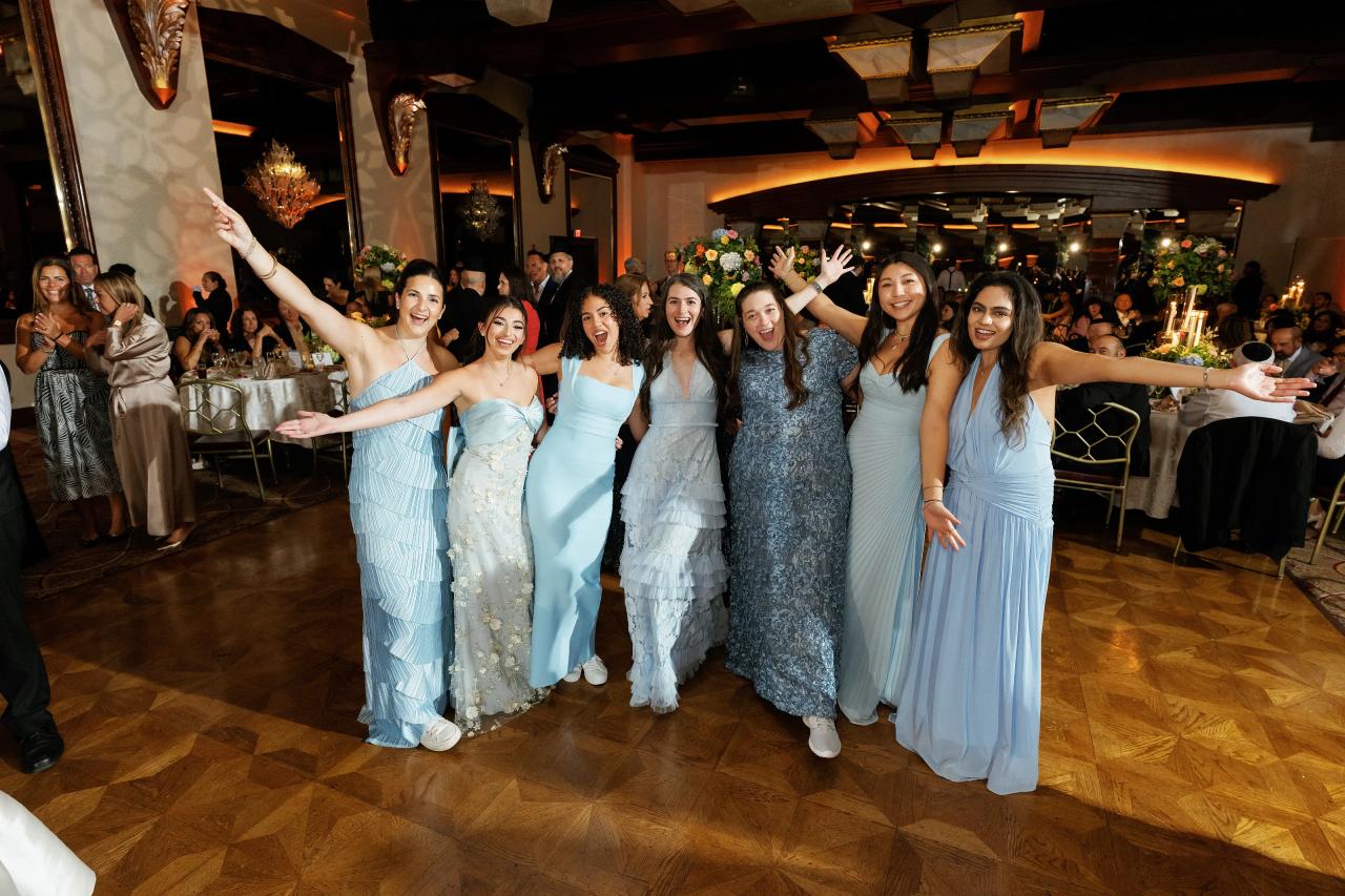 Wedding party celebrating together in the reception ballroom. Crest Hollow wedding in Woodbury, Long Island.
