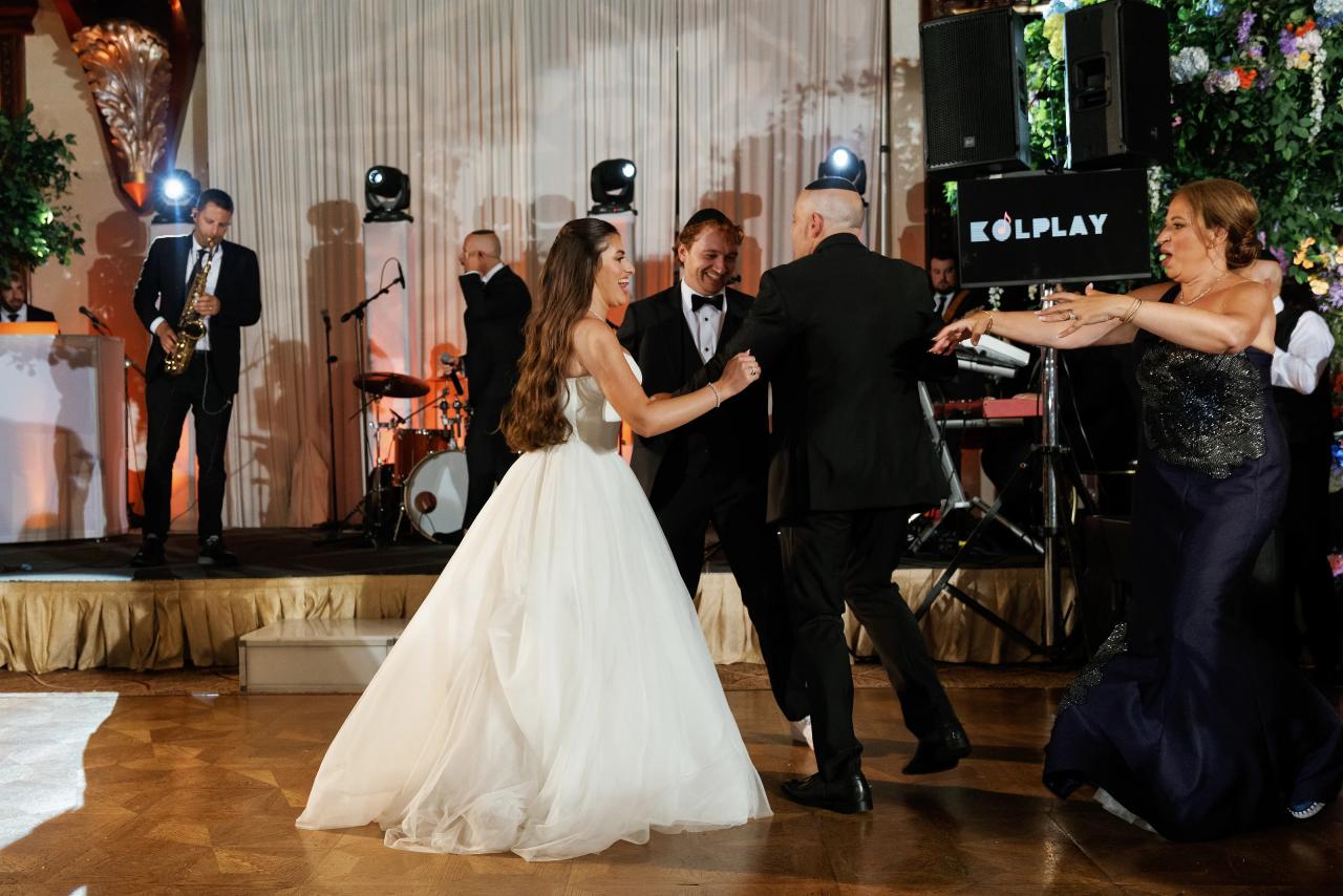Bride and groom dancing with guests at the reception. Crest Hollow wedding in Woodbury, Long Island.