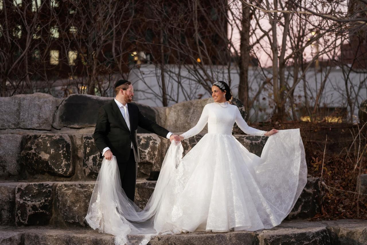 Bride displaying her wedding dress on stone garden steps. Wedding portraits in Brooklyn, NYC.
