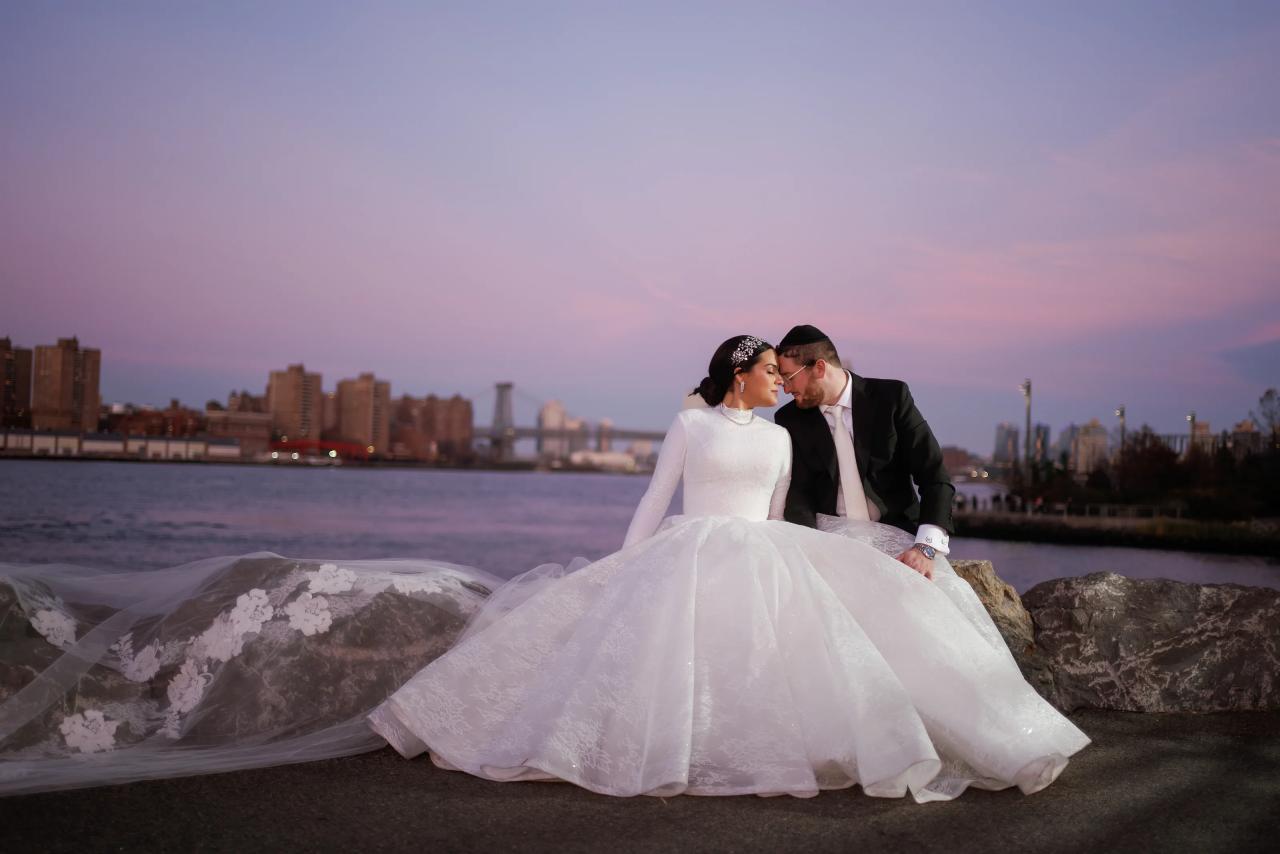 Wedding couple touching foreheads at the waterfront after sunset. Wedding portraits in Brooklyn, NYC.