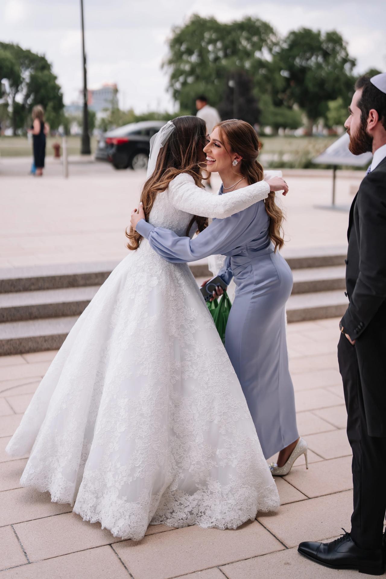 Bride greeting a guest before the ceremony. Jewish wedding in Detroit.