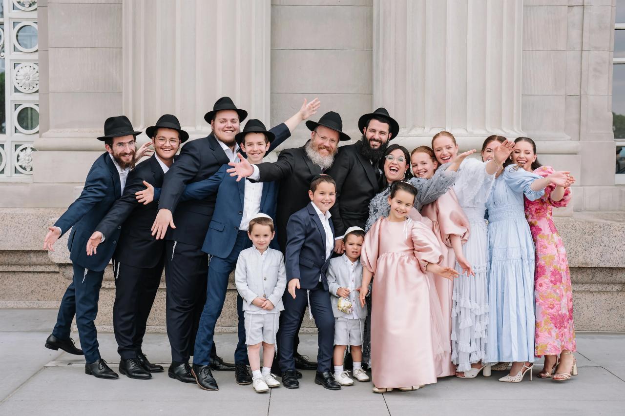 Wedding family sharing a playful group portrait. Jewish wedding in Detroit.
