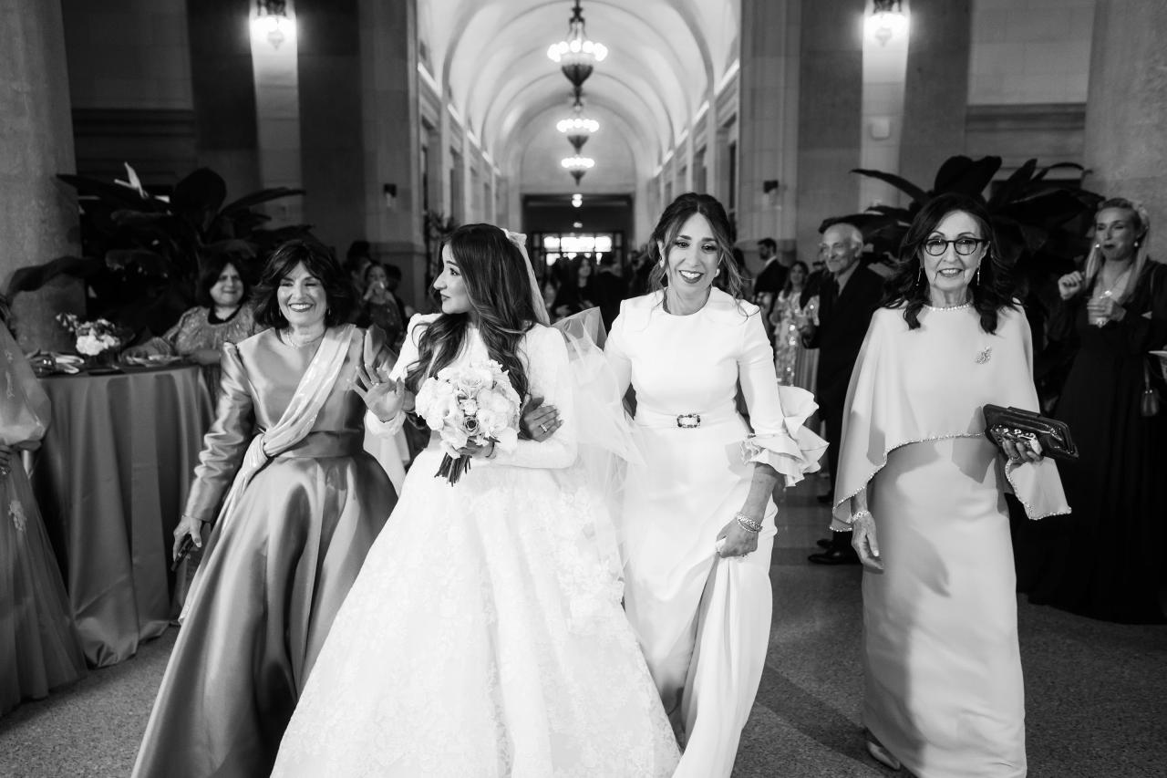 Black-and-white bride walking with family before the ceremony. Jewish wedding in Detroit.