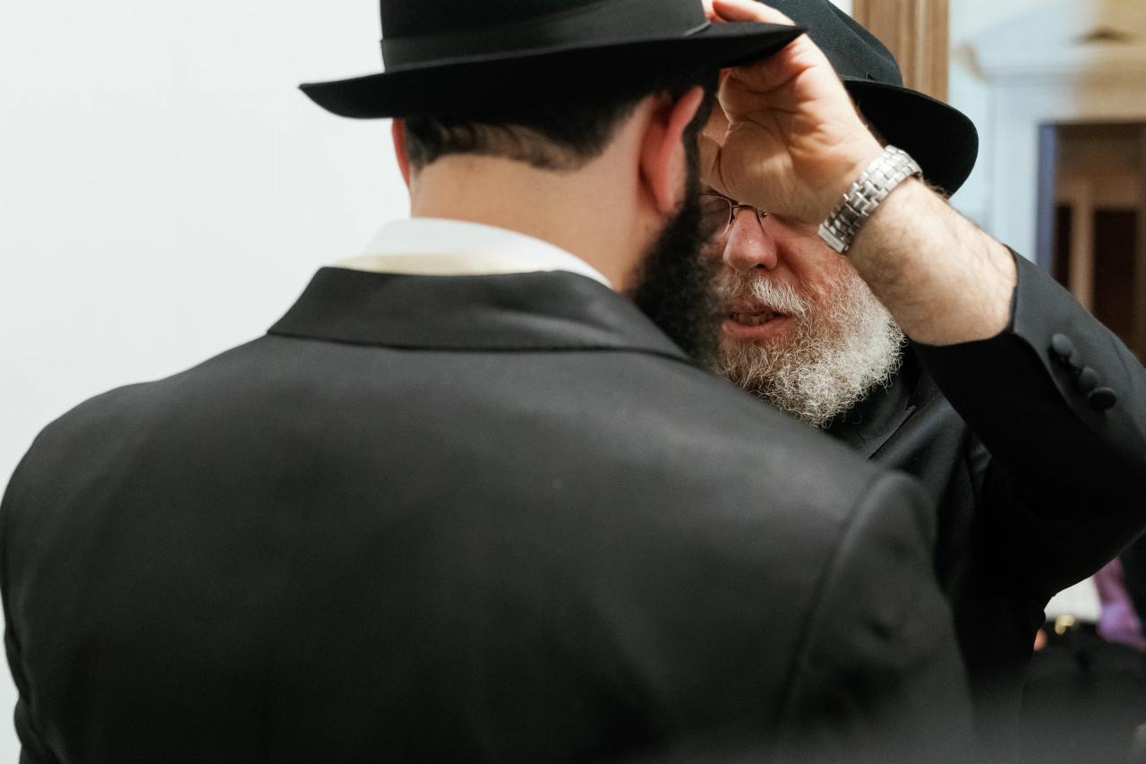 Groom receiving a family blessing before the chuppah. Jewish wedding in Detroit.