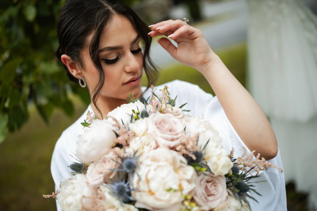 Close bridal portrait with a bouquet of cream and blush flowers. Wedding at Indian Ridge.
