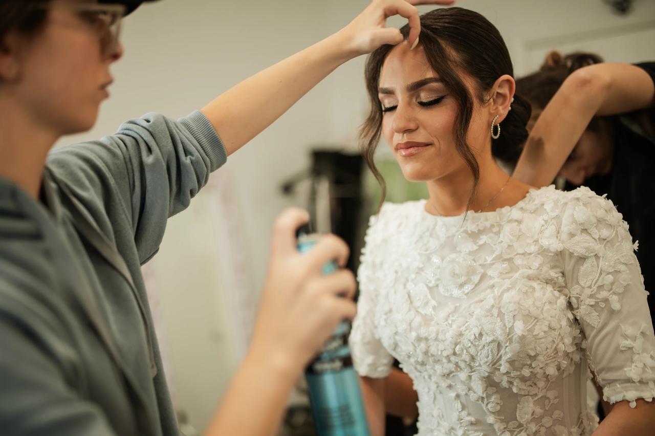 Bride receiving finishing touches before the wedding. Wedding at Indian Ridge.
