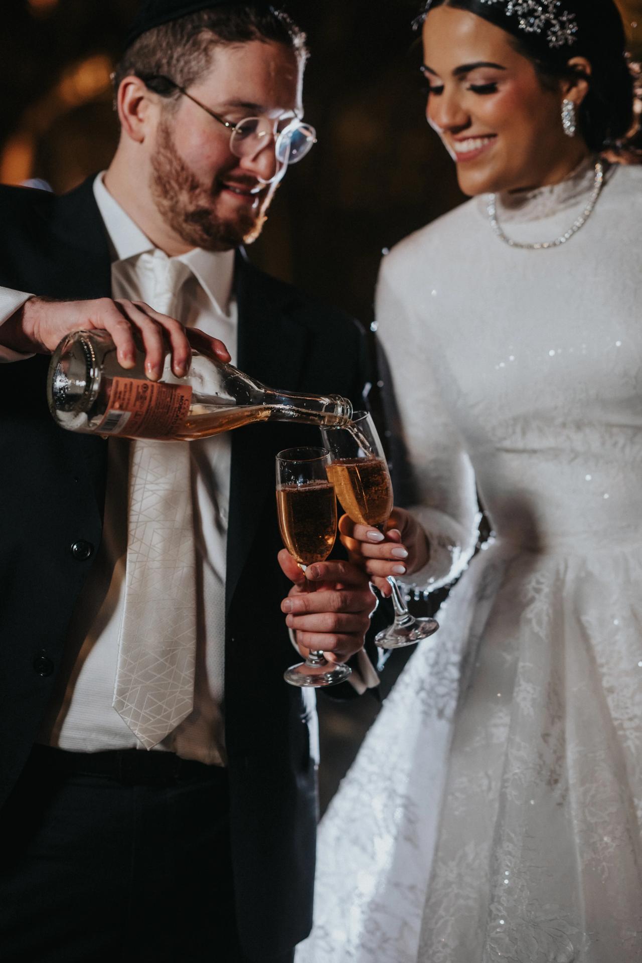 Bride and groom pouring a celebratory drink. Wedding portraits in Brooklyn, NYC.