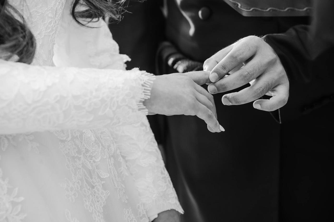 Black-and-white detail of the wedding ring exchange. Jewish wedding in Detroit.