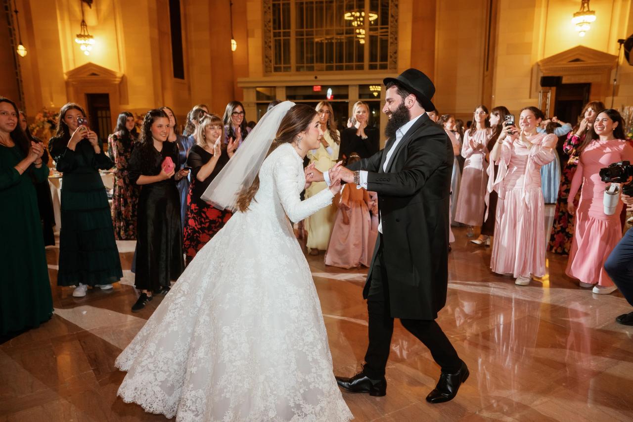 Bride and groom dancing together with wedding guests. Jewish wedding in Detroit.