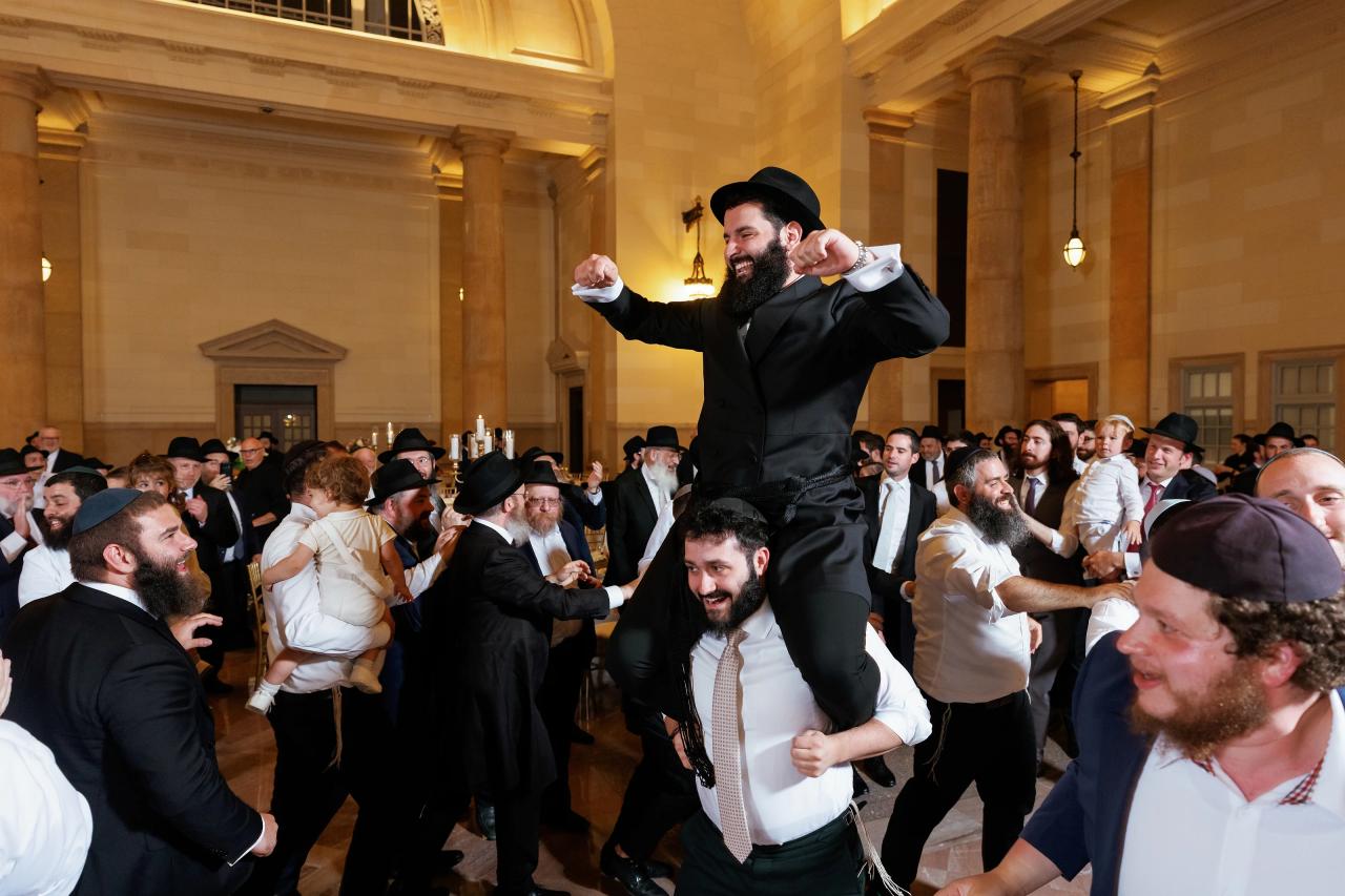 Groom lifted above the wedding reception dance floor. Jewish wedding in Detroit.