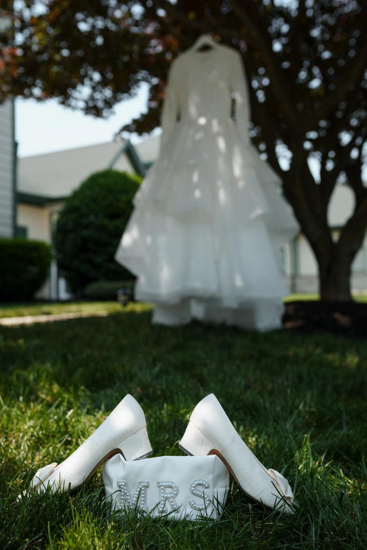 Bridal gown and wedding shoes arranged before getting ready. Jewish wedding in Baltimore.