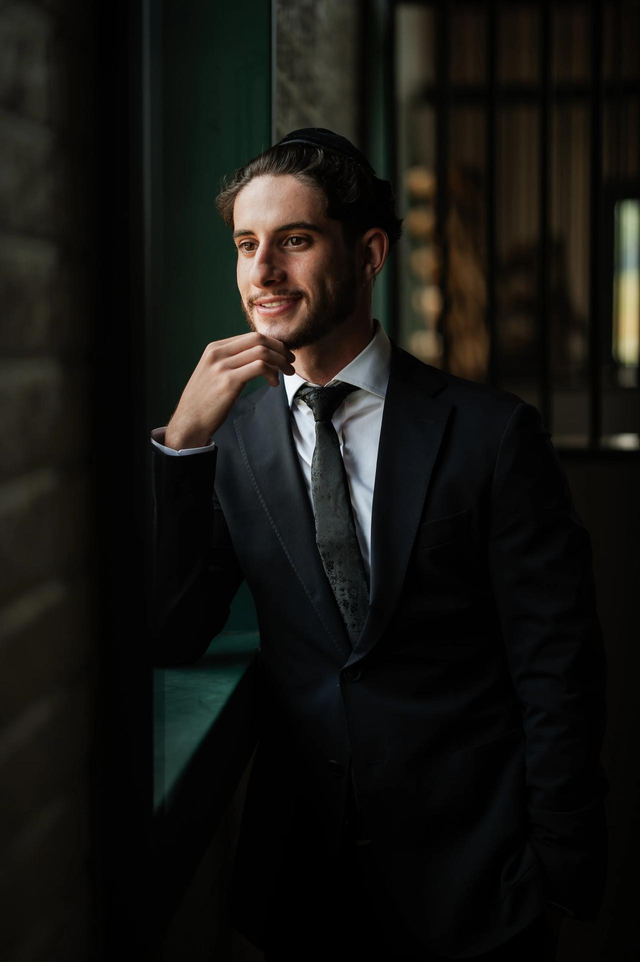 Groom portrait in dramatic window light. Jewish wedding in Baltimore.