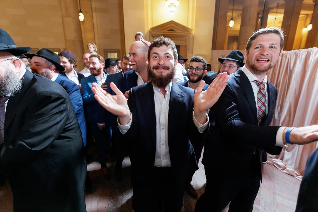Wedding guests celebrating together in the ballroom. Jewish wedding in Detroit.