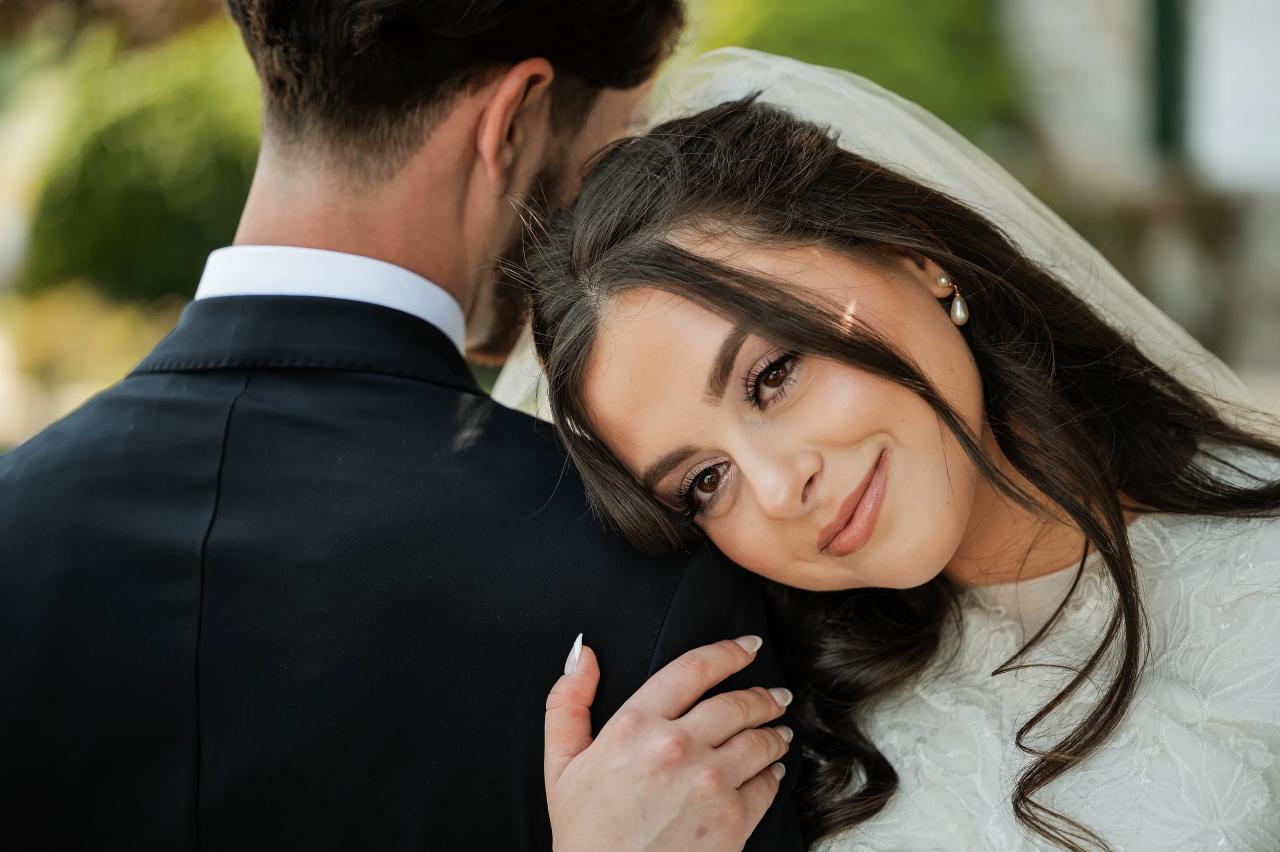 Bride resting her head on the groom shoulder. Jewish wedding in Baltimore.