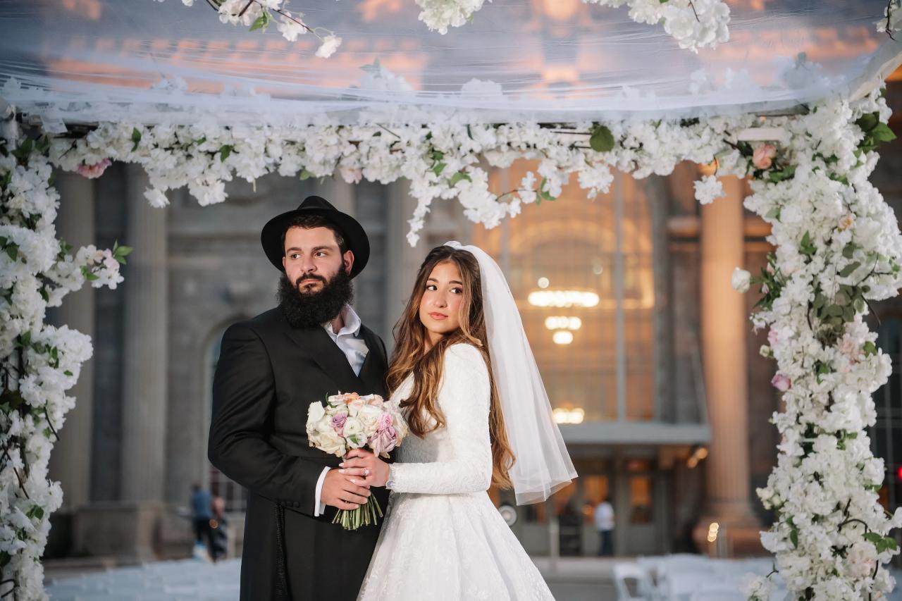 Close wedding portrait framed by flowers and the evening sky. Jewish wedding in Detroit.